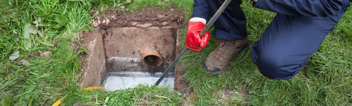 a drain cleaner is cleaning a drain inside a property